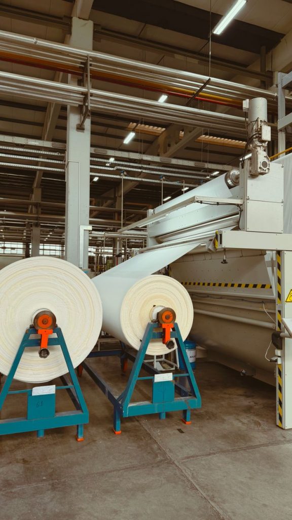 Textile machinery with large spools in an Uzbekistan factory.